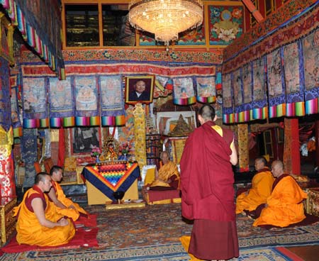 The 11th Panchen Lama Bainqen Erdini Qoigyijabu (C in front), one of the two most senior living Buddhas in Tibetan Buddhism, recites sutra in front of his sutra teacher Jamyang Gyamco and other senior lamas during a ceremony for his receiving the bhikku (monk) ordination at Tashilhunpo Monastery in Xigaze, southwest China's Tibet Autonomous Region, July 25, 2009.