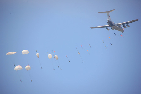 Russian paratroopers parachute during the real-combat of the 'Peace Mission-2009' joint anti-terror military exercise in Taonan of northeast China's Jilin Province, July 26, 2009. More than 100 tanks, self-propelled cannons, as well as more than 60 aircraft are fighting against 'terrorists' in the 80-minute final performance of the five-day exercises. 