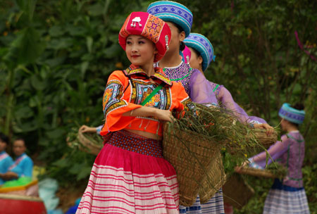  Girls of Miao ethnic group perform 'Herb Picking' at the opening of the Original Folk Culture Festival held in Qingzhen City of southwest China's Guizhou Province, July 26, 2009. Series of activities like folk culture tours, ethnic-styled competitions, folk custom photo shows, drug bathing, etc. will be held during the festival. (Xinhua/Jin Yulong)
