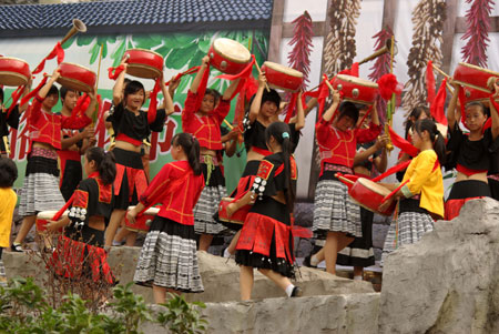 Performers give stage show at the opening of the Original Folk Culture Festival held in Qingzhen City of southwest China's Guizhou Province, July 26, 2009. Series of activities like folk culture tours, ethnic-styled competitions, folk custom photo shows, drug bathing, etc. will be held during the festival. (Xinhua/Jin Yulong) 