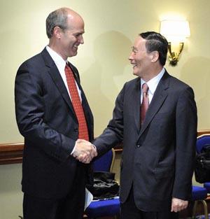 Chinese Vice Premier Wang Qishan meets with Rick Larson (L) in Washington, D.C., on July 26, 2009, the day before the first round of the China-U.S. Economic and Strategic Dialogue, which is to be held in Washington, D.C. from July 27 to 28. [Zhang Yan/Xinhua] 