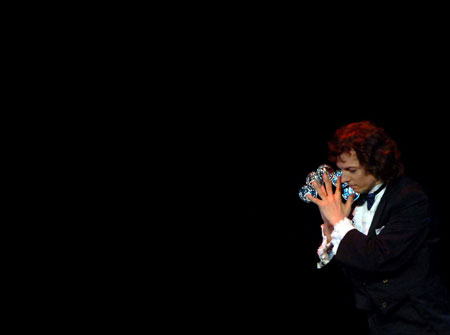 Greek magician Martino performs during the stage competition of the 24th World Magic Championships of the International Federation of Magic Societies (FISM) held in Beijing, capital of China, on July 27, 2009.