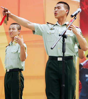 Policemen of Changchun armed police detachment perform during a performance in Changchun, capital of northeast China's Jilin Province, July 28, 2009, to celebrate the forthcoming 82nd anniversary of the founding of the Chinese People's Liberation Army. [Yao Qilin/Xinhua]