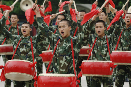 Policemen of Anhui armed police contingent play drums during a rehearsal for the celebration of the forthcoming 82nd anniversary of the founding of the Chinese People's Liberation Army in Hefei, capital of east China's Anhui Province, July 28, 2009. [Li Jian/Xinhua]