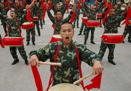 Policemen of Anhui armed police contingent play drums during a rehearsal for the celebration of the forthcoming 82nd anniversary of the founding of the Chinese People's Liberation Army, in Hefei, capital of east China's Anhui Province, July 28, 2009. [Li Jian/Xinhua]