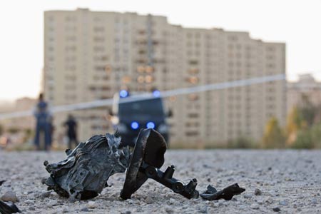 A piece of debris lies on the road in front of a Civil Guard barracks after a car bomb exploded in the northern Spanish city of Burgos, early July 29, 2009.[Xinhua/Reuters]