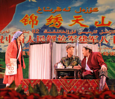 Artists of song and dance ensemble of Xinjiang Art Theater give a performance for police officers in Urumqi,Xinjiang Uygur Autonomous Region, July 29, 2009. [Xinhua]