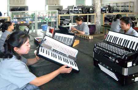 The photo released by KCNA news agency on July 29, 2009 shows workers assemble accordions in the Pyongyang Musical Instrument Factory in Pyongyang, the Democratic People's Republic of Korea. [Xinhua/KCNA] 