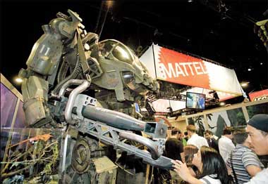People walk past a huge 'Avatar' amp suit at the Mattel booth at Comic-Con International 2009 Convention held in San Diego .