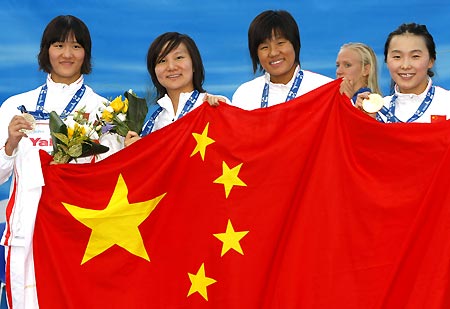 Pang Jiaying, Liu Jing, Zhu Qianwei and Yang Yu (L to R) pose for photos at poduim in Rome, Italy, July 30, 2009. China snatched the women's 4x200m freestyle relay gold medal in a world record time of seven minutes 42.08 seconds at the world swimming championships here on Thursday. [Xinhua]