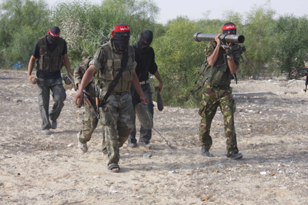 Palestinian militants of the Democratic Front for the Liberation of Palestine (DFLP) participate in a drill in front of the media in the southern Gaza Strip town of Rafah on July 30, 2009. [Xinhua]