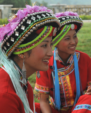 Two girls of the Yi ethnic group are seen in their traditional ceremonial clothes at Keyi Village of Mile County, southwest China's Yunnan Province, July 29, 2009. Axi is a branch of the Yi ethnic group with a history of over 300 years. Keyi Village generated the significant dance of the Yi ethnic group, Axi dance, which is performed during Axi people's celebration for harvest and victory. (Xinhua/Chen Haining)