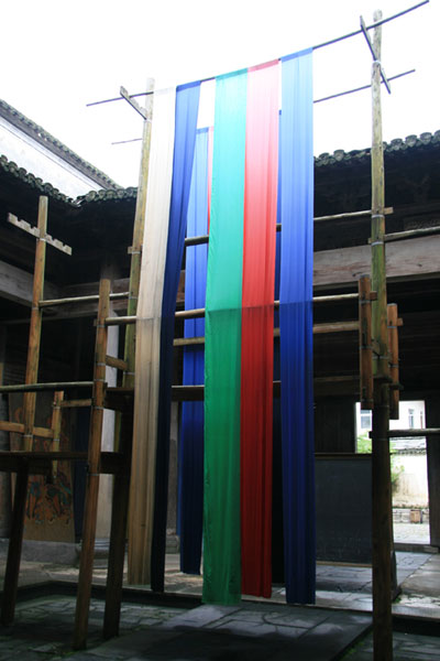 A colorful meter-long cloth hangs in the patio of Xuzhi Hall, or Ye's Ancestral Hall, where Zhang Yimou's Oscar-nominated film 'Ju Dou' was shot in 1990. [Photo: CRIENGLISH.com]