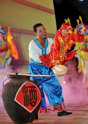 An actor performs during a fishermen's festival in Lingao, a county of south China's Hainan Province, July 30, 2009. The festival was held here on Thursday as the midsummer moratorium on fishing in the South China Sea was ending. 