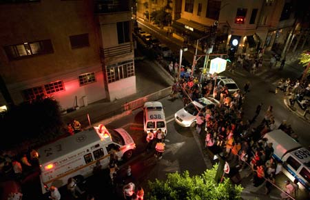 Israeli police and paramedics work at the scene of a shooting attack at a gay community house in Tel Aviv. [Xinhua/AFP]