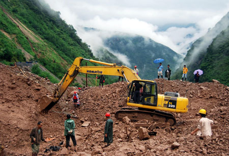 Rescuers search for bodies of the victims in mudslides in Jinyang of southwest China's Sichuan Province, Aug. 1, 2009. All of the bodies of 9 victims in mudslides caused by heavy rains in Jinyang were found on Saturday. All the nine people missing in mudslides caused by heavy rains in southwest China's Sichuan Province were dead as the last two bodies were recovered over the weekend, the provincial government said late Sunday. [Xinhua]