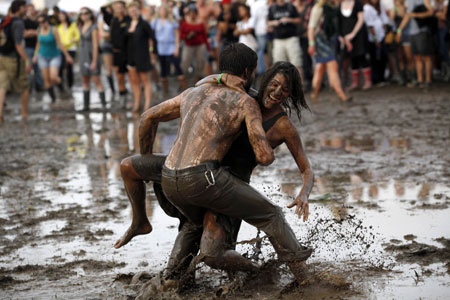 Concert goers play in the mud during the All Points West music festival at Liberty State Park in Jersey City, New Jersey August 2, 2009. [Xinhua/Reuters] 