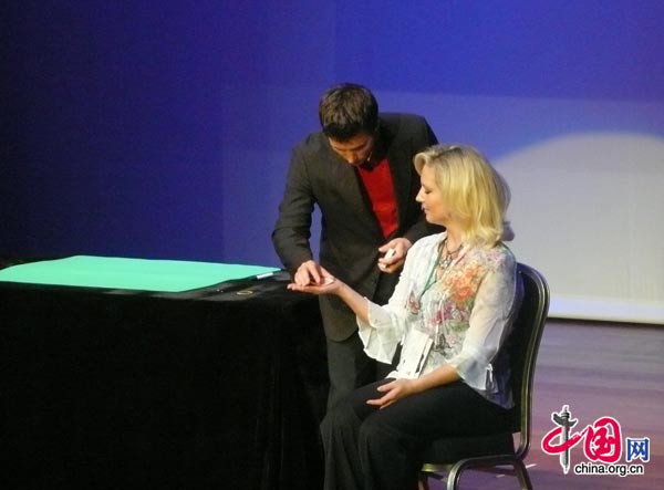 A magician competes on stage in Beijing at the FISM World Championships of Magic. The conference attracts professional magicians from all around the world and is held every three years in a different city. [Yan Xiaoqing/China.org.cn]