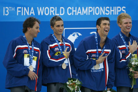 Aaron Peirsol, Eric Shanteau, Michael Phelps and David Walters (L to R) of the U.S. relay team celebrate on the podium during the awarding ceremony of the men's 4X100m medley relay at the 13th FINA World Championships in Rome, Aug. 2, 2009. The U.S. team won the gold and set a new world record with 3:27.28. 