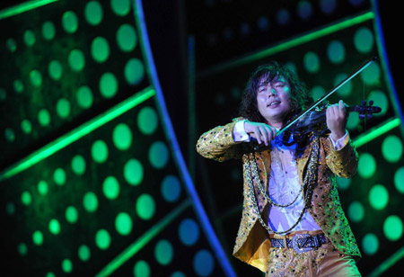 An actor plays violin during a 