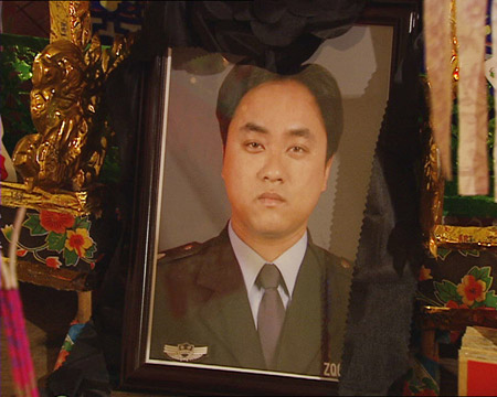 A frame grab taken from TV footage shows the file photo of Zhang Aiming, a security guard stabbed to death when he assisted police in inspection in Pudong New Area of Shanghai, August 3, 2009. The police have locked up the suspect. Since the foundation of the People's Republic of China in 1949, there have been 10,768 police officers killed in the course of duty and 151,468 officers injured, said China's Ministry of Public Security (MPS) Monday. [Xinhua]