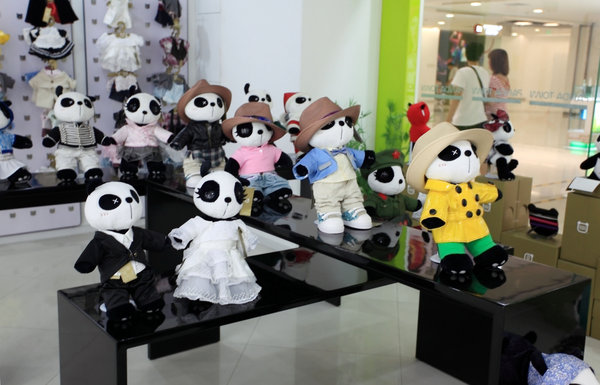 Panda Town toys are displayed in a store on August 2, 2009 in Beijing, China. The Panda Town brand is established by some youth who were born in the 1980's and came back from study abroad. They use Chinese element to decorate the panda toys and to make the brand famous as Barbie in American. [Photo by ChinaFotoPress] 