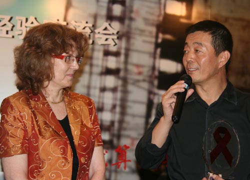 Leading director Gu Changwei (R) thanks Constance Thomas, Director of the International Labour Office for China and Mongolia while holding the award for his contribution to 'Hometown Fellows' Campaign on August 3, 2007. [Li Shen/China.org.cn] 