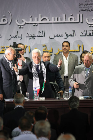 Palestinian National Authority Chairman and Leader of the Fatah movement Mahmoud Abbas (2nd L, front), arrives at the opening ceremony of the sixth general conference of Fatah, which kicks off in the West Bank city of Bethlehem, Aug. 4, 2009. [Xinhua]