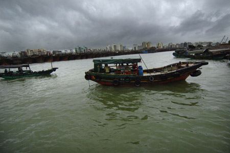 Boats are seen at a harbor where many boats and ships take shelter from tropical storms in Haikou, capital of south China's Hainan Province, on Aug. 5, 2009.