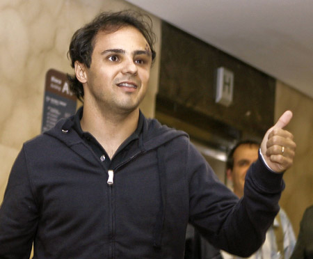 Brazilian Formula One driver Felipe Massa of the Ferrari team gives the thumbs up as he arrives at a hospital in Sao Paulo August 3, 2009. Massa suffered a head injury on July 25 at the qualifying for the Hungarian Grand Prix and spent several days in a coma and on a respirator.