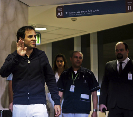 Brazilian Formula One driver Felipe Massa of the Ferrari team waves as he arrives at a hospital in Sao Paulo August 3, 2009. Massa suffered a head injury on July 25 at the qualifying for the Hungarian Grand Prix and spent several days in a coma and on a respirator. 