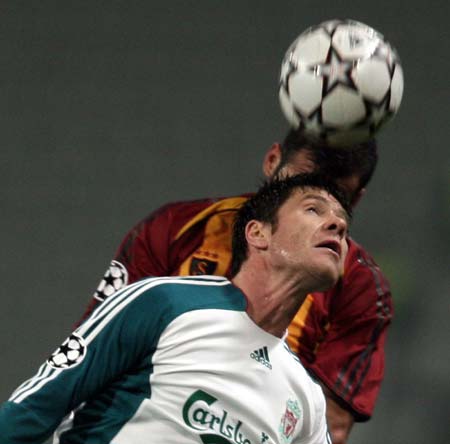 Liverpool's Xabi Alonso fights for a header ball with Galatasaray's Umit Karan (rear) during their Champions League Group C soccer match at Ataturk Olympic Stadium in Istanbul December 5, 2006. 