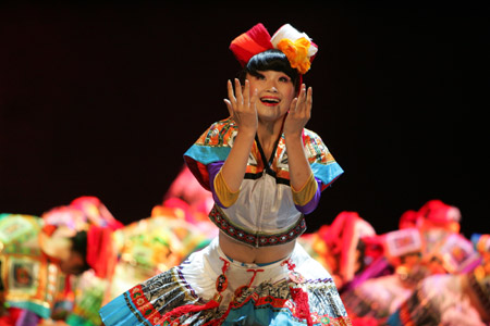 A performer dances during a competition of traditional dances of ethnic groups in southwest China's Guizhou Province, in Guiyang, capital of Guizhou Province, on Aug. 4, 2009. 