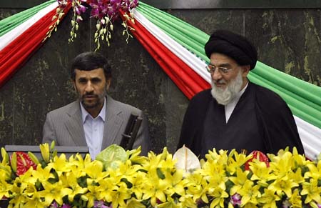 Iranian President Mahmoud Ahmadinejad (L) is sworn in as he stands next to Iran's judiciary chief Mahmoud Hashemi Shahrudi during a ceremony in front of parliament in Tehran. Ahmadinejad was sworn in as Iranian president as riot police broke up opposition protests over an election that triggered the worst turmoil in the Islamic republic's history.[Xinhua/AFP] 