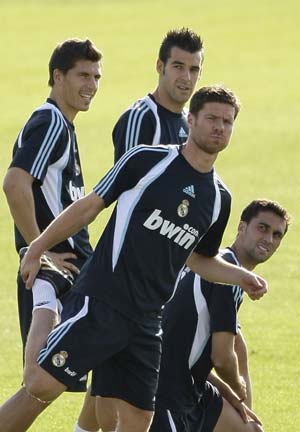 Real Madrid's Xabi Alonso (front) attends his first training session with his team mates (from L) Agus, Alvaro Negredo and Alvaro Arbeloa at Valdebebas training grounds outside Madrid August 5, 2009. Real Madrid have ended their search for new signings with the deal to land Spain midfielder Xabi Alonso from Liverpool and will now focus on trimming their squad, director general Jorge Valdano said on Wednesday.
