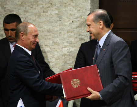 Turkish Prime Minister Tayyip Erdogan (R) shakes hands with his Russian counterpart Vladimir Putin after they signed a deal to allow the planned Russian-backed South Stream gas pipeline to go through Turkey's Black Sea waters in Ankara, capital of Turkey, August 6, 2009. Russian Prime Minister Putin was in Ankara for a one-day working visit. [Xinhua/Anatolia News Agency]