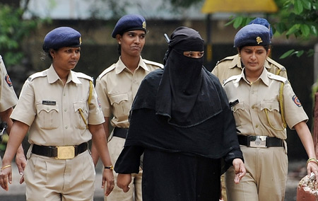 Fehmida Syed (centre, wearing burqa), one of the prime accused in the Mumbai 2003 twin bombings, is escorted out of the Byculla Women's Jail in Mumbai on August 6. In a landmark judgment a special Indian court in Mumbai Thursday sentenced three terrorists, belonging to Pakistan-based banned militant outfit Laskhar-e-Toiba(LeT), to death for carrying out two bomb explosions which rocked Mumbai in 2003 killing 52 people. [Xinhua/AFP]