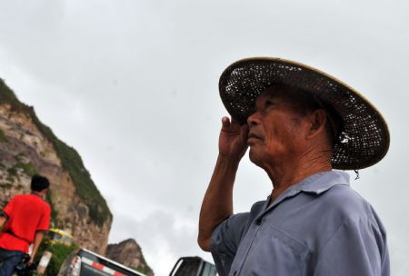 A fisherman observes the weather in Wenling, east China's Zhejiang Province, on August 6, 2009. The eye of Typhoon Morakot was located at 840 kilometers east off Fuzhou City of southeast China's Fujian Province as of 11 a.m. Thursday. 