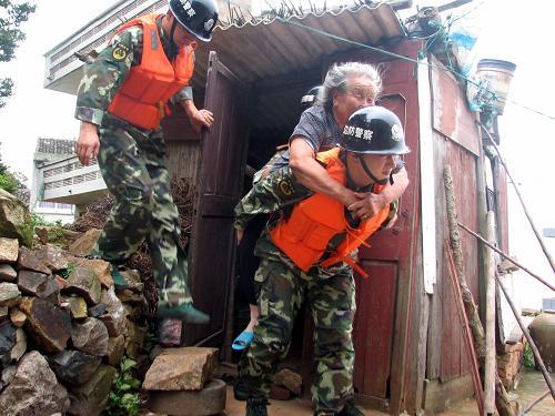 Soldiers help an old lady evacuate in Luxi Isaland in Wenzhou, Zhejiang Province, on August 8. Weather forecasters said late Saturday typhoon Morakot was likely to land on the coast from Cangnan, Zhejiang Province, to Xiapu, neighboring Fujian Province, between 8 AM and 10 AM Sunday.