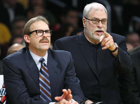 Los Angeles Lakers assistant coach Kurt Rambis (L) wears a 1970's style moustache and glasses as he sits with coach Phil Jackson during their NBA basketball game against the Boston Celtics in Los Angeles, December 30, 2007.(Xinhua/Reuters File Photo) 