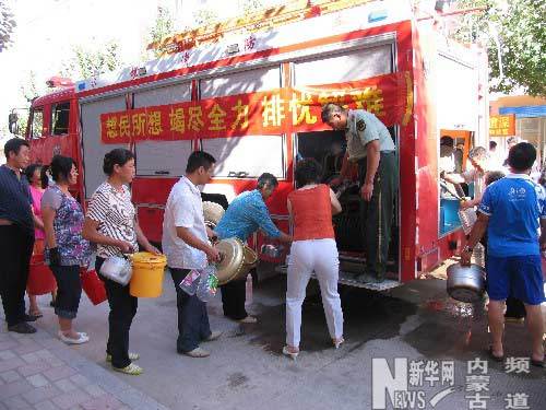 In the picture taken on August 4, 2009people line up for drinking water supplied by local fire trucks in Xincheng District of Chifeng City, Inner Mongolia Autonomous Region.