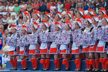 Miao girls perform at the opening ceremony of Julan Cultural Festival in Huangping, a county of southwest China's Guizhou Province, Aug. 8, 2009. [Chen Peiliang/Xinhua]