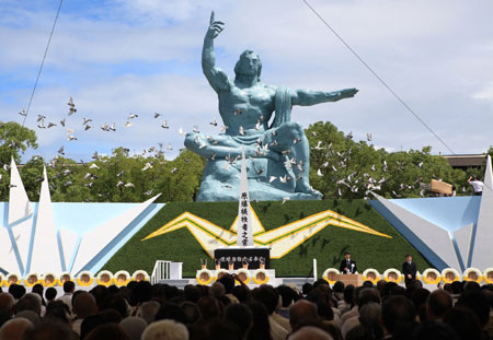 Doves fly around the statue at the peace memorial park after being released for the 64th memorial ceremony for atomic bomb victims in Nagasaki, western Japan, on Aug. 9, 2009.More than 5,000 people gathered Saturday in the Peace Park in Nagasaki to mark the 64th anniversary of the U.S. atomic bombing of the southwestern Japanese city. [Xinhua/AFP]