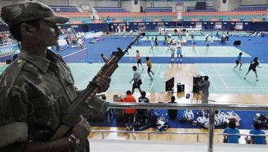 A security guard stands guard inside an indoor badminton stadium ahead of the world badminton championships in the southern Indian city of Hyderabad August 9, 2009.[CCTV/Reuters]