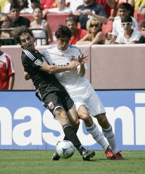 Real Madrid's Kaka (R) fights for the ball against DC United's Dejan Jakovic during first half of their friendly soccer match in Landover, Maryland, August 9, 2009.(Xinhua/Reuters Photo) 