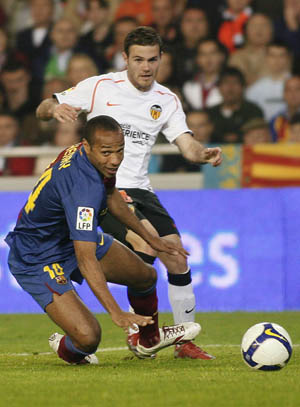 Barcelona's Thierry Henry (L) and Valencia's Juan Mata fight for the ball during their Spanish first division soccer match at the Mestalla Stadium in Valencia April 25, 2009.