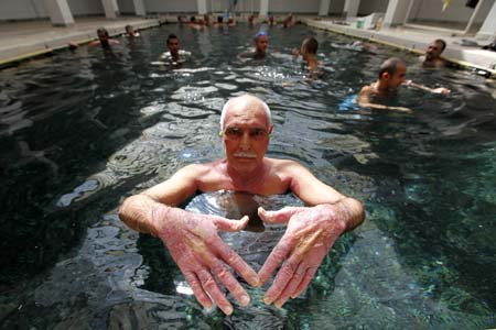 A psoriasis patient displays his hands as he relaxes in a hot spa pool as part of his treatment in Kangal, 105 kilometers (65 miles) south of the central Anatolian city of Sivas August 8, 2009.