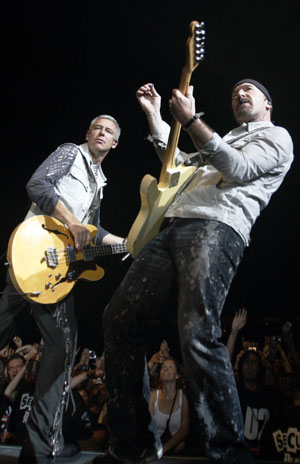 Adam Clayton (L) and Edge of U2 performs during their 