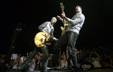 Adam Clayton (L) and Edge of U2 perform during their 