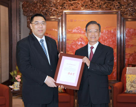 Chinese Premier Wen Jiabao (R) awards the instrument of appointment as the new chief executive of the Macao Special Administrative Region (SAR) to Chui Sai On, in Beijing, capital of China, on Aug. 11, 2009.